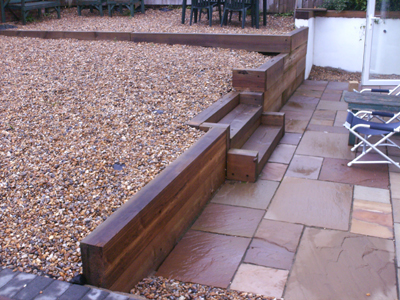 Patio Indian Sandstone wall in wooden sleepers,steps and pebble garden 106.jpg